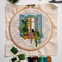 the embroidery kit is next to some scissors and thread