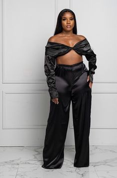 Solid Color: Black Satin Pant Set Twist crop top details Long sleeves Off shoulder Elastic waist Wide leg palazzo pants 97% polyester, 3% spandex Hand wash cold Model is wearing a large Satin Pants Outfit, Satin Top Blouses, Twist Crop Top, Satin Pant, Wide Leg Palazzo Pants, Satin Pants, Satin Top, Pant Set, Palazzo Pants