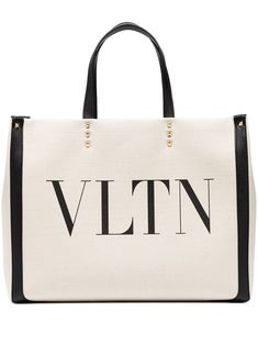 Ecru/black canvas small VLTN logo canvas tote from VALENTINO GARAVANI featuring logo print to the front, two top handles, magnetic fastening, main compartment, multiple internal slip pockets and internal logo patch. Designer Canvas Tote Bag For Shopping, Designer Canvas Shoulder Bag With Logo, Designer Canvas Bag In Tan, Designer Tan Canvas Bags, Travel Shoulder Bag With Logo Print In Cotton, Travel Cotton Shoulder Bag With Logo Print, Designer Cotton Tote Shoulder Bag, Designer Cotton Bags For Daily Use, Designer Canvas Shoulder Bag With Embroidered Logo