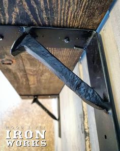 an iron work is attached to the side of a building with nails stuck in it