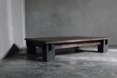 a wooden table sitting on top of a cement floor