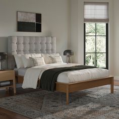 a bedroom with a bed, nightstands and rug in it's center area