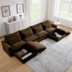 a living room with a large sectional couch and coffee table on the floor in front of it