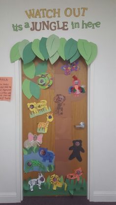 a door decorated with jungle animals and leaves