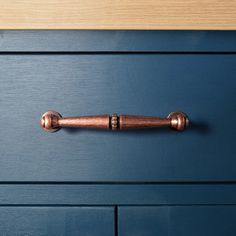 a blue drawer with a wooden handle on it