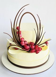 a white cake with red flowers on top