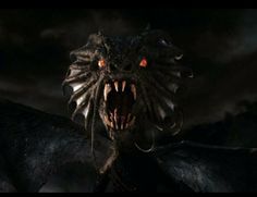 a large black dragon with its mouth open