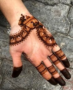 a hand with henna tattoos on it