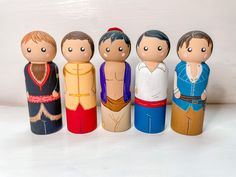 a group of wooden dolls standing next to each other