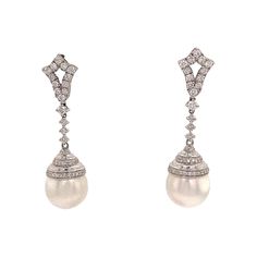 18K White gold earrings featuring two South Sea Pearls measuring 11-12 mm and 82 round brilliants weighing 0.90 carats Color G Clarity VS-SI Luxury Cream Pearl Drop Jewelry, Luxury Vintage Diamond White Diamond Earrings, Elegant Pave Setting Diamond Earrings For Formal Occasions, Elegant Formal Diamond Earrings With Pave Setting, Classic Formal Diamond Drop Earrings, Formal Diamond Pearl Earrings With Brilliant Cut, Formal Brilliant Cut Diamond Pearl Earrings, Classic Platinum Pearl Earrings For Formal Occasions, Formal Pave Setting Diamond Earrings