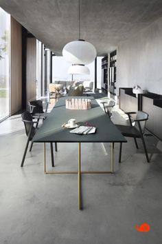 a long table with books on it in the middle of a room