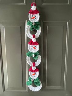 crocheted snowman wreath hanging on the front door