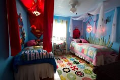 a child's bedroom decorated in blue and red