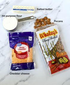 ingredients needed to make peanut butter pretzels on a marble counter top, including salted butter, pecans, and peanuts