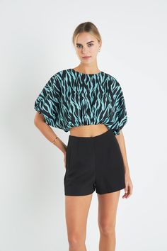 Make a fierce fashion statement in our Tiger Print Voluminous Cropped Top. With its bold and eye-catching tiger print it's the perfect piece to express your wild side. This crop top features a balloon hem for a voluminous look and is fully lined for added comfort. Stand out from the crowd in this fashionable and fun top perfect for any occasion. Tiger print Crop length Balloon hem Fully lined Hand wash cold Do not bleach Do not tumble dry Iron low Shell: 95% Polyester 5% Spandex Lining: 80% Polyester 20% Cotton Exclusive of Elastic TL623T Total length: 17" Bust: 64" Graphic Print Cropped Top For Night Out, Chic Printed Tops For Night Out, Fitted Black Top With Tiger Print, Fitted Black Tiger Print Top, Trendy Zebra Print Tops For Spring, Summer Short Sleeve Tops With Tiger Print, Chic Summer Tops With Zebra Print, Bold Short Sleeve Summer Tops, Trendy Black Zebra Print Tops