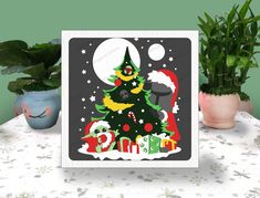 a christmas card with an image of a tree and presents on the table next to potted plants