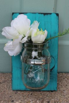 there is a mason jar with flowers in it