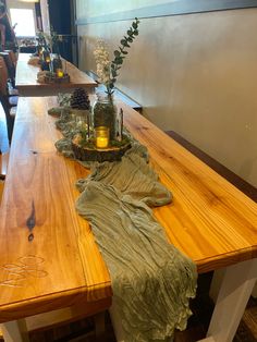 a wooden table topped with vases filled with flowers