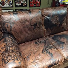 an old leather couch with tattoos on it