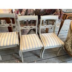 four chairs sitting next to each other on a wooden floor