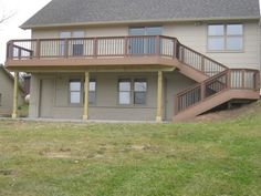 a two story house with stairs leading up to the second floor and another level above it