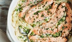 salmon and pasta with peas in a white bowl