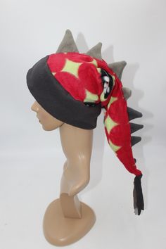 This listing is for the hat pictured, you will receive this exact hat.   With its eye-catching pattern and long row of spikes, everyone you encounter will wonder where you got such a great hat and will want one for themselves! Hat is sized to fit any ages from 4 years old and up- fits kids, adults, and teens alike. Extra stretchy, wonderfully warm band with ear flaps make this hat perfect for anyone! Feel free to ask for a custom sized hat, we will make one in any mix of colors/patterns, sized j Stocking Hats, Dinosaur Tails, Stocking Hat, Hat Scarf, Ski Snowboard, Exercise For Kids, Gray Green, Green Flowers, Snowboarding