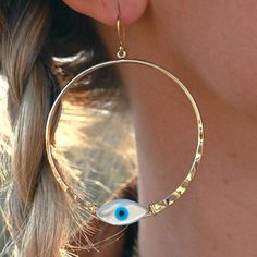 These gorgeous hoops are the perfect earrings to wear with a simple tee, dress up with a black dress or rock on a zoom call. The Mother of Pearl evil eye shimmers in the light with its pearl essence. Let these earrings be your reminder to always protect your peace, just as an evil eye protects. 2" gold plated hoops Mother of Pearl evil eye Weight: 1/8 oz Handmade in Arizona Peace Earrings, Protect Your Peace, Meaningful Jewelry, Simple Tees, Zoom Call, Hammered Gold, Rock On, Mala Necklace, Quartz Necklace