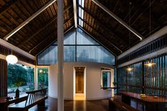 the inside of a building with wooden floors and windows on both sides, along with wood benches