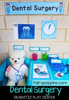 a teddy bear sitting in front of a dental surgery table with pictures on the wall