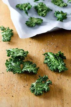 chopped broccoli sitting on top of a wooden table next to a white cloth