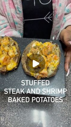 two stuffed steak and shrimp baked potatoes on a slate board with the words stuffed steak and shrimp baked potatoes