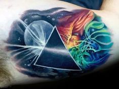 a man's arm with a colorful tattoo on it and an image of a triangle