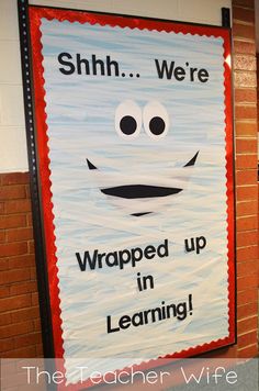 a sign that says shh we're wrapped up in learning on the wall