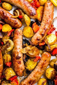 sausages, potatoes and peppers on a white plate