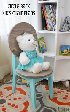 a white teddy bear sitting on top of a chair in front of a book shelf