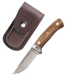 a knife with a brown leather sheath next to it's blade and sheath holder