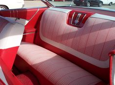 the interior of a red and white car