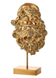 a golden santa claus head on a wooden stand