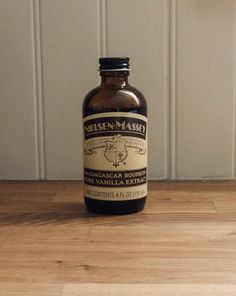 a bottle of medicine sitting on top of a wooden table