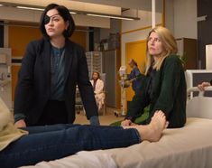 two women sitting on a bed in a hospital