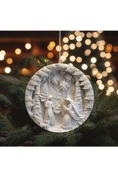 a white ornament hanging from a christmas tree