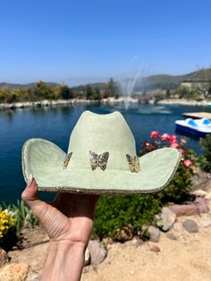 sage green/ light green hat with yellow gold rhinestones on the bottom brim.  Beautiful butterflies line the trim.  This is one size fits most, there's a drawstring to adjust sizing.  ships in 2 business days! Stunning in person  Perfect for Coachella , stagecoach, Nashville, country concerts, bachelorette parties, brides, weddings Please note that the hats are handmade and may have some variances and blemishes. If any, they are very minor . The hats might have a bit of "stickiness" from the glu Green Western Hats For Spring, Green Western Style Hats For Spring, Green Hat Bands For Rodeo With Short Brim, Green Short Brim Hat Bands For Rodeo, Green Summer Hat For Rodeo, Green Western Hat Bands For Summer, Green Wide Brim Western Hat, Western Green Hat Bands For Kentucky Derby, Green Western Hat Bands For Kentucky Derby