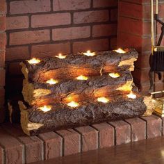 a fire place with candles on it in front of a brick fireplace