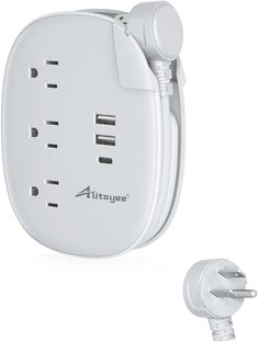 an image of a white wall outlet with three outlets and two plugs attached to it