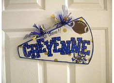 a door hanger that says, ohfyn'e on it with blue and gold confetti