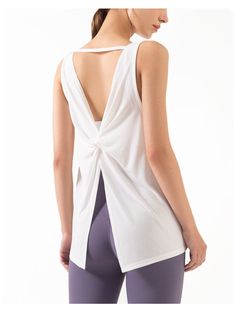 The EMES SHOP tank top is detailed with a scoop neckline. and thick tank straps that connect in an open triangle back. Features a twist detail mid-back. and flares out to an open split that can be tied and falls below the hips. This light-weight. super breathable tank is perfect for laying over sports bras for a run. workout. hike. yoga. or even simply every day wear.MATERIAL: 70% Modal. 30% PolyesterMEASUREMENTS: Small | Bust: 41" cm . Length: 60" cm Medium | Bust: 43" cm . Length: 62" cm Large | Bust: 45" cm . Length: 64" cm XL | Bust: 47" cm . Length: 66" cm MEASUREMENTS: Small | Bust: 16.14" in . Length: 23.6" in Medium | Bust: 16.9" in . Length: 24.4" in Large | Bust: 17.7" in . Length: 25.2" in XL | Bust: 18.5" in . Length: 26" in Casual Backless Tie Back Tank Top, Casual Backless Tie-back Tank Top, Casual Backless Tank Top With Tie Back, Backless Yoga Tops With Built-in Bra, Chic Sleeveless Gym Top, Backless Workout Tops With Built-in Bra, Stretch Backless Tie Back Tank Top, Stretch Backless Tie-back Tank Top, Stretch Backless Tank Top With Tie Back