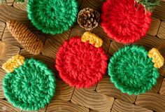 crocheted christmas ornaments with pine cones on wooden background, closeup view from above