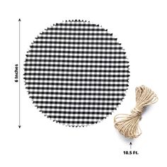 a black and white checkered round rug next to a twine of twine