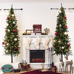 a living room decorated for christmas with stockings on the fireplace